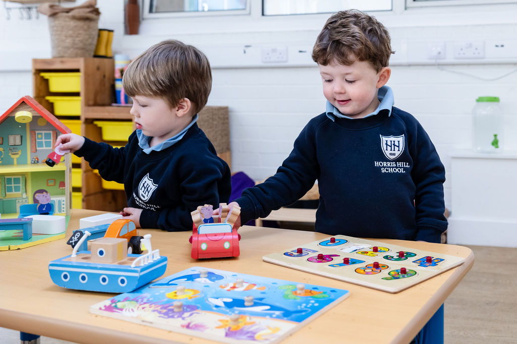 Children playing with toys at a play table in Nursery